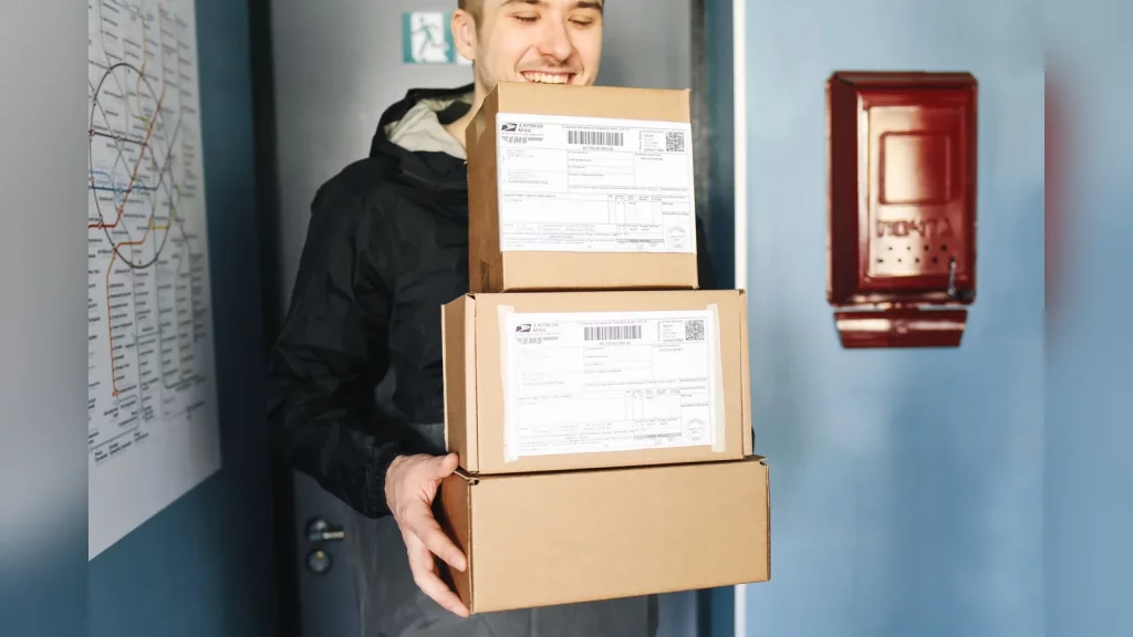 A shopper holding a smartphone collects a small parcel at a Kazpost branch in Kazakhstan, in a candid everyday scene with natural light and no text or promotional banners.