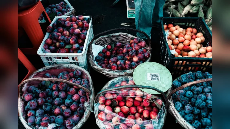 Покупатель выбирает продукты у прилавка фермера на сельскохозяйственной ярмарке у ипподрома «Қазанат» в Астане. Живая осенняя сцена, без текста.