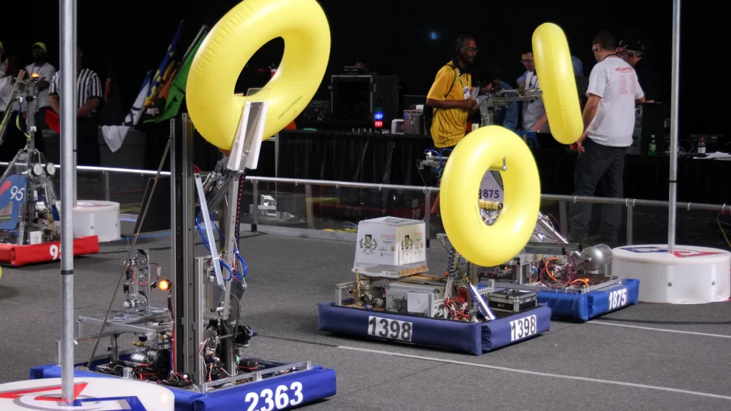 Educational mobile robots competing on the FIRST Robotics Competition arena (illustrative)