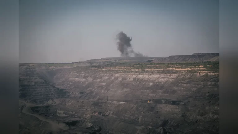 A wide view of the Vasilkovskoye gold deposit near Kokshetau, showing the terraced open pit and mining equipment at work, with no text.